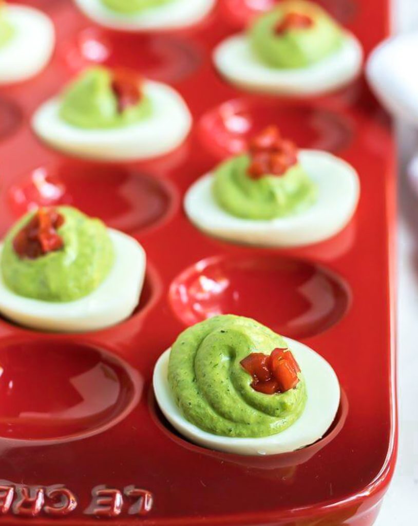 deviled eggs in red serving dish