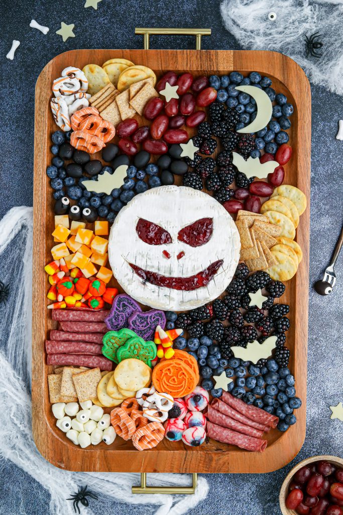 assorted snacks on wooden tray