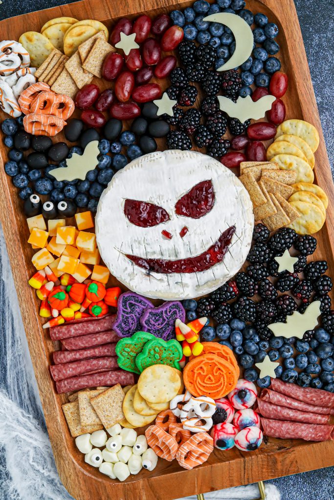 brie cheese with skeleton face carved into it