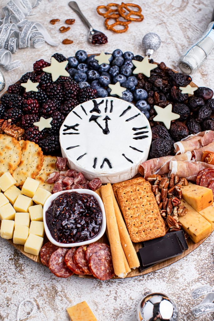 charcuterie assortment with brie cheese clock